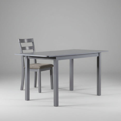 Modern 59-inch extendable dining table in a dark gray finish, expanded to seat up to 8 people with solid rubberwood legs.
