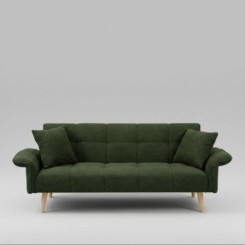 Green sofa in a living room with decorative elements and a lamp.