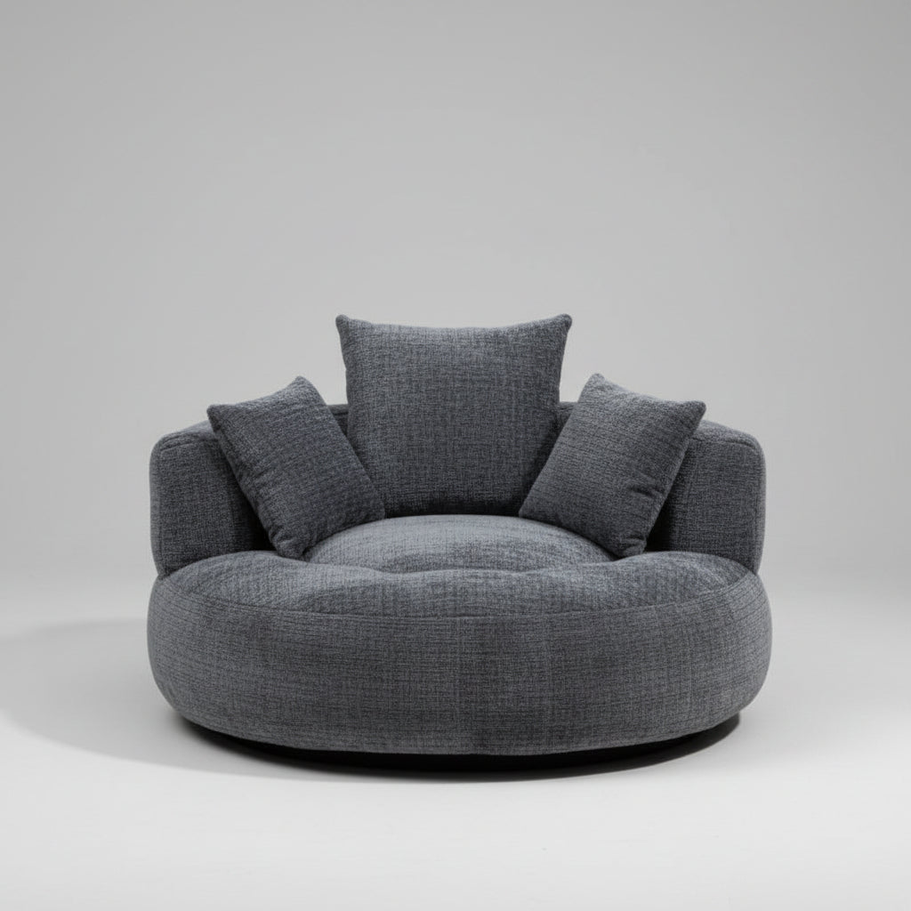 Gray cushioned chair in a modern living room setting with shelves and plants.