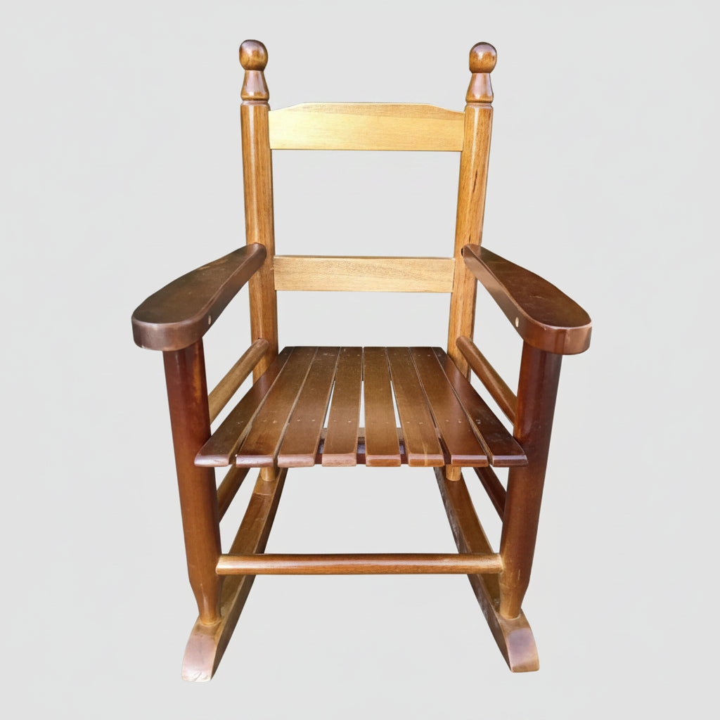 Classic children's solid oak rocking chair with a secure slatted backrest designed for indoor nurseries and outdoor patios.
