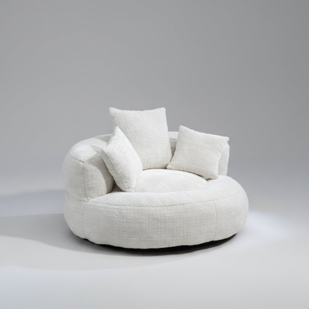 Round white sofa with cushions in a modern living room setting