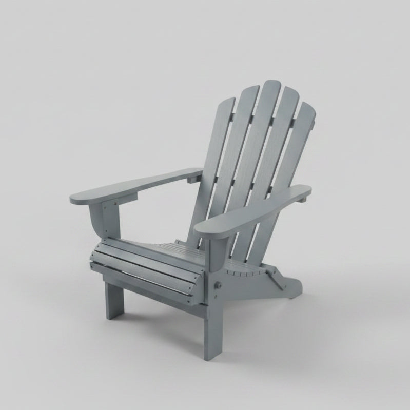Classic gray solid wood Adirondack chair with a foldable frame and wide armrests placed on an outdoor backyard wooden deck.