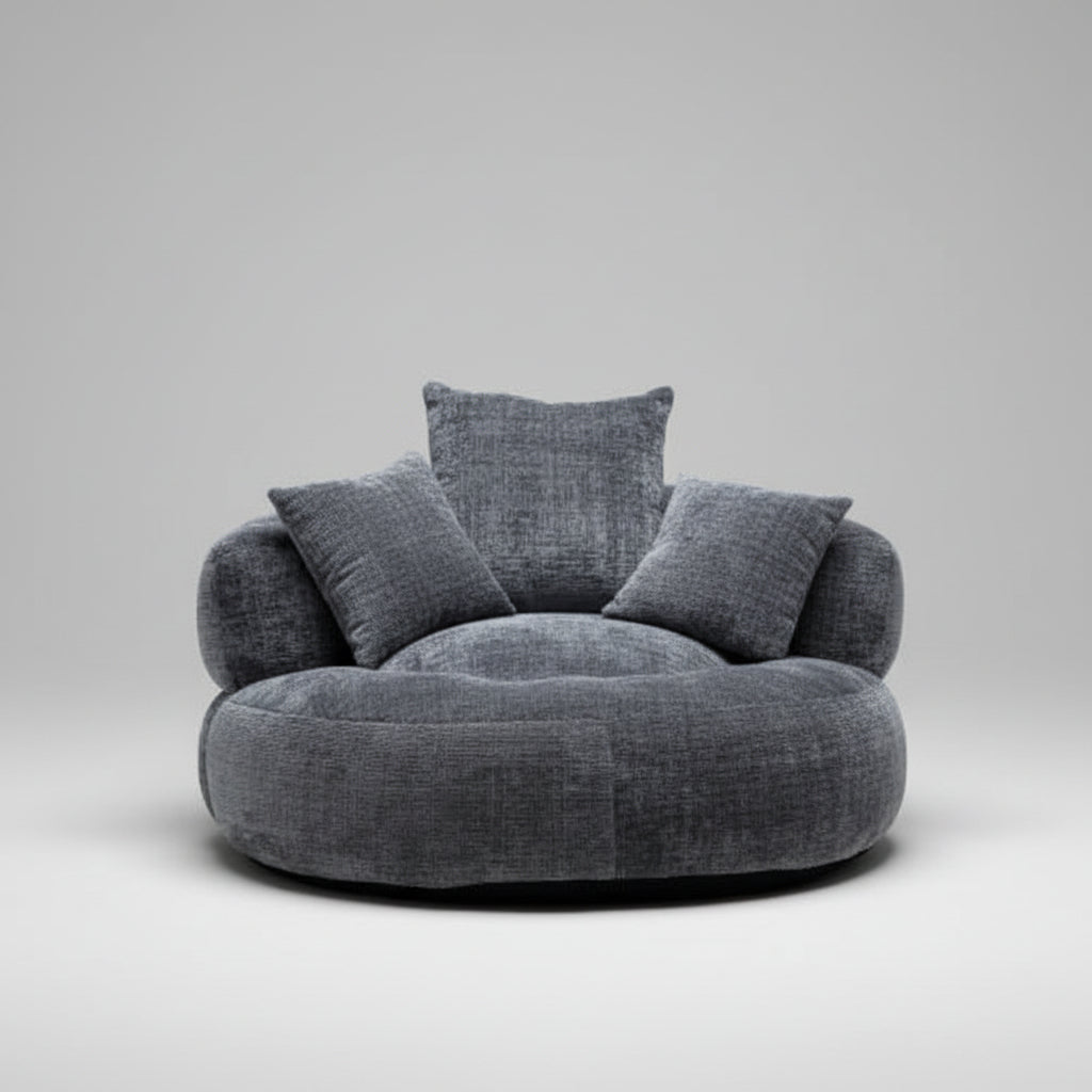 Gray textured armchair in a modern living room setting with shelves and plants.